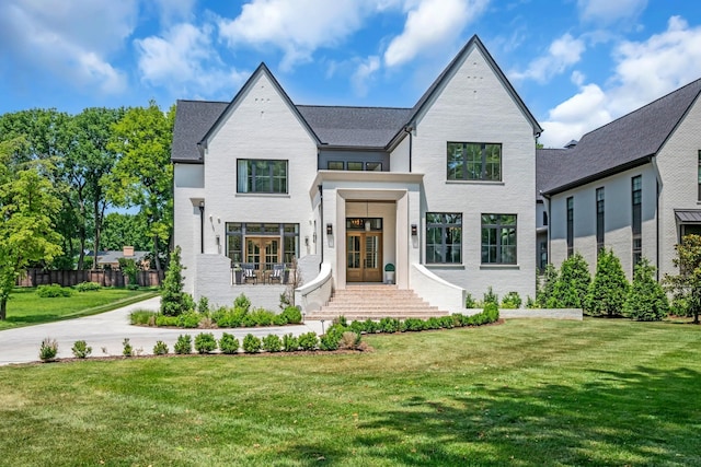 view of front facade with a front yard and french doors