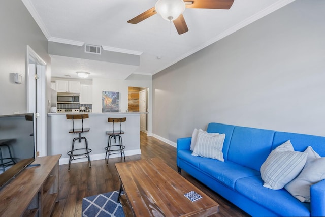 living room with ornamental molding and dark hardwood / wood-style floors