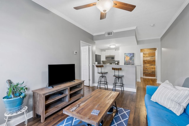 living room with ceiling fan, dark hardwood / wood-style flooring, and crown molding