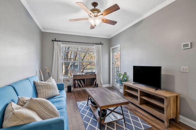 living room featuring ceiling fan, dark hardwood / wood-style flooring, and ornamental molding