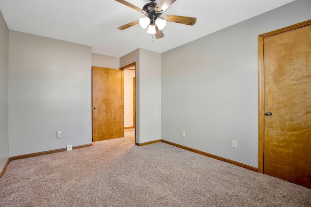 unfurnished room featuring ceiling fan, carpet floors, and a textured ceiling