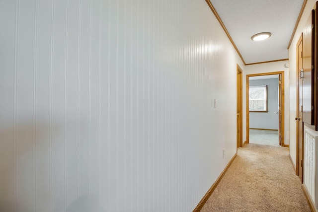 hallway with light carpet and ornamental molding