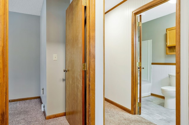 hallway featuring light colored carpet