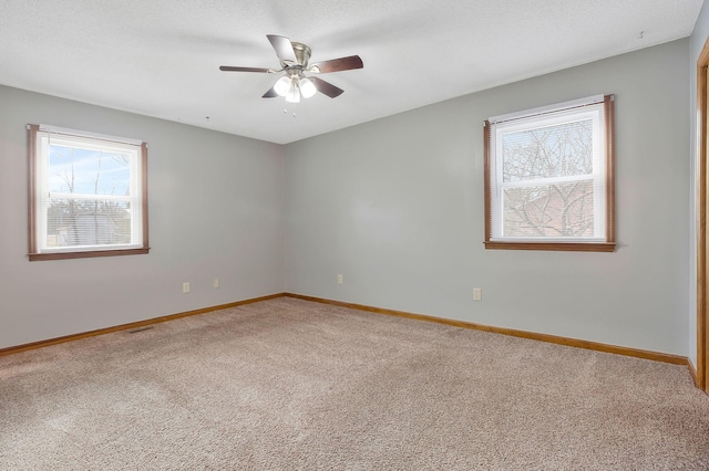 unfurnished room with ceiling fan and carpet flooring