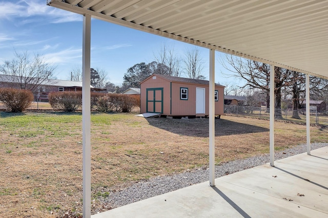 view of yard featuring a storage unit and a patio area