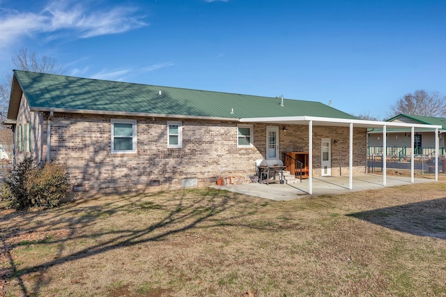 rear view of property with a patio area and a lawn