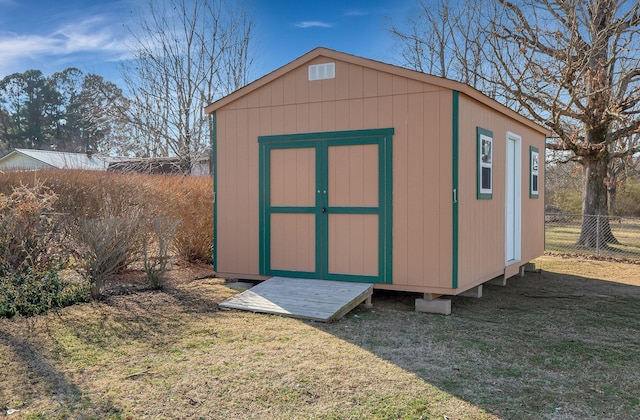 view of outbuilding featuring a yard