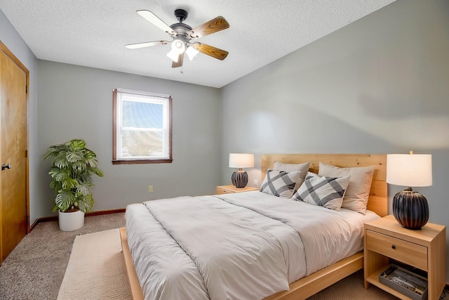 carpeted bedroom with ceiling fan and a textured ceiling