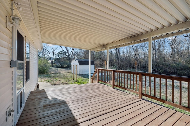 wooden terrace featuring a shed