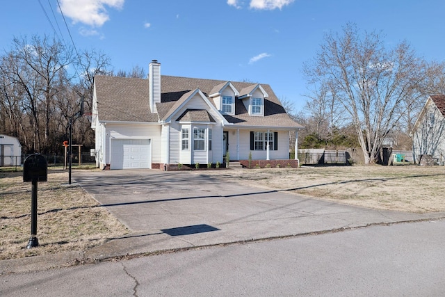 cape cod-style house featuring a garage