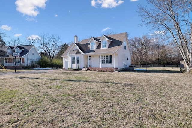 cape cod home featuring a front yard