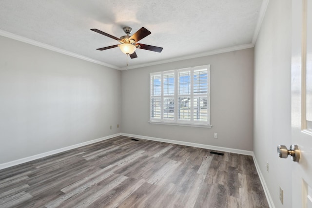 spare room featuring ceiling fan, dark hardwood / wood-style floors, crown molding, and a textured ceiling