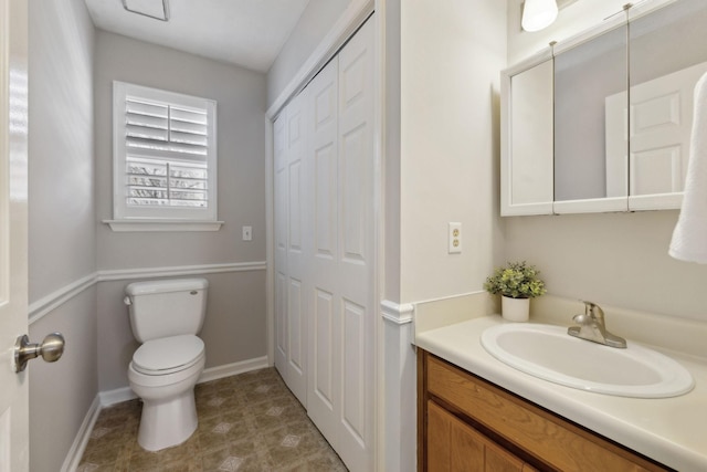 bathroom featuring toilet and vanity