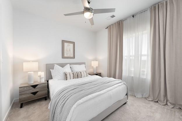 carpeted bedroom with ceiling fan