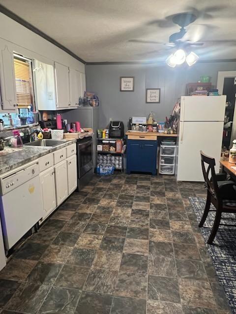 kitchen featuring ceiling fan, blue cabinetry, white appliances, white cabinets, and sink