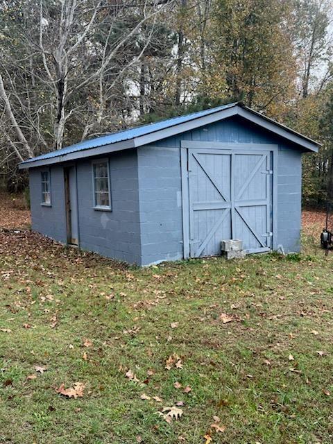 view of outbuilding featuring a yard