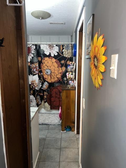 corridor featuring tile patterned flooring