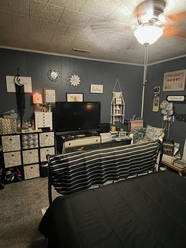 bedroom with ceiling fan and ornamental molding