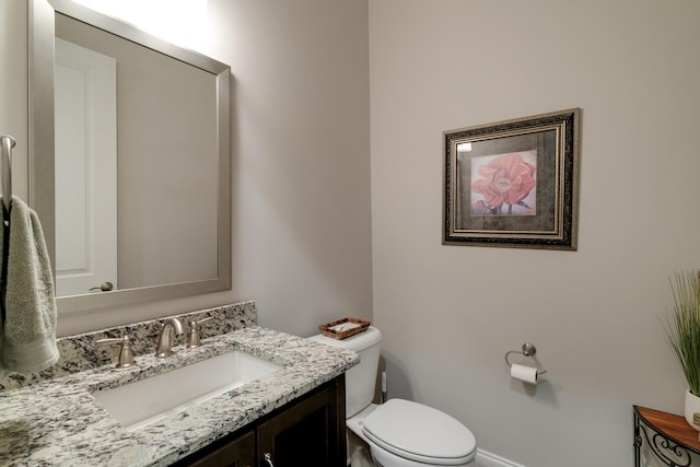 bathroom featuring toilet and vanity