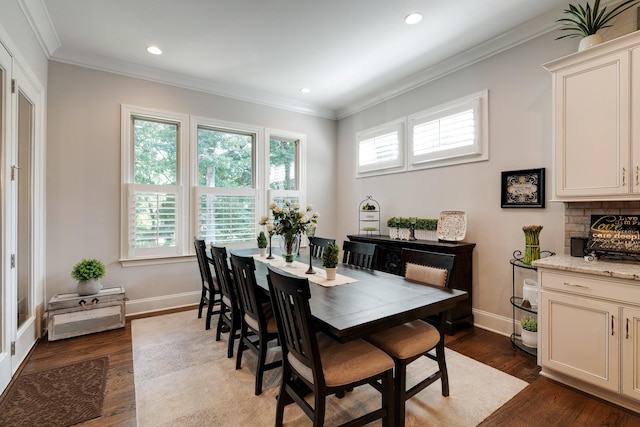 dining area with dark wood-type flooring and ornamental molding