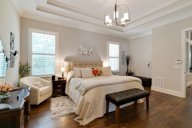 bedroom with a raised ceiling, dark wood-type flooring, an inviting chandelier, and crown molding