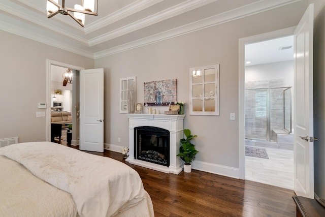 bedroom featuring ornamental molding, dark hardwood / wood-style floors, and a notable chandelier