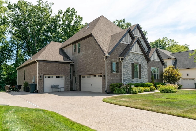 view of front of home with a front lawn and a garage