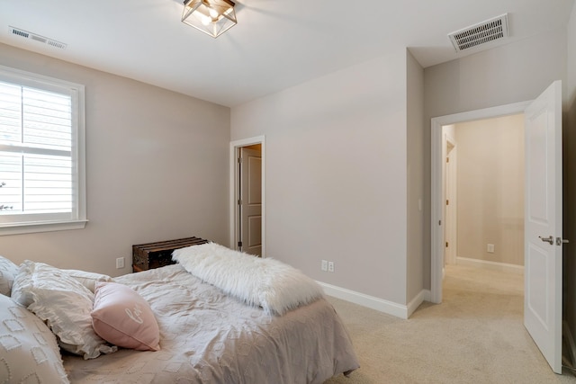 bedroom featuring light colored carpet