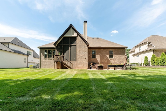 rear view of property featuring a lawn, central air condition unit, and a patio