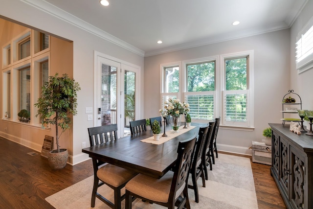 dining area featuring crown molding and hardwood / wood-style flooring