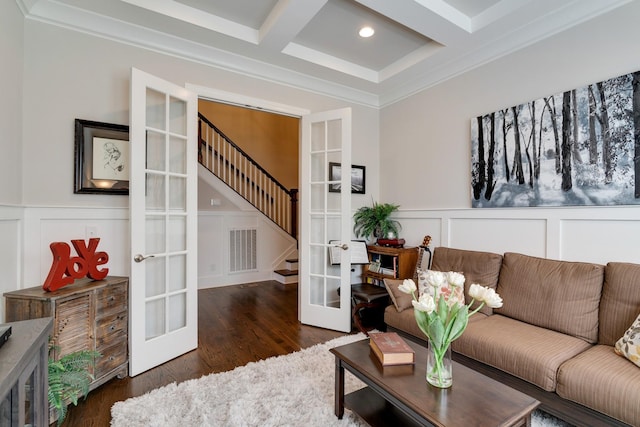 living room featuring coffered ceiling, crown molding, french doors, and beamed ceiling