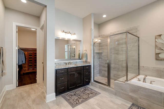 bathroom featuring separate shower and tub and vanity