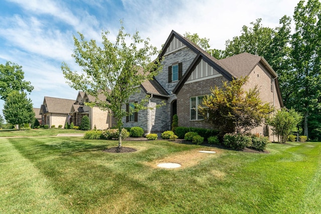 english style home with a front yard