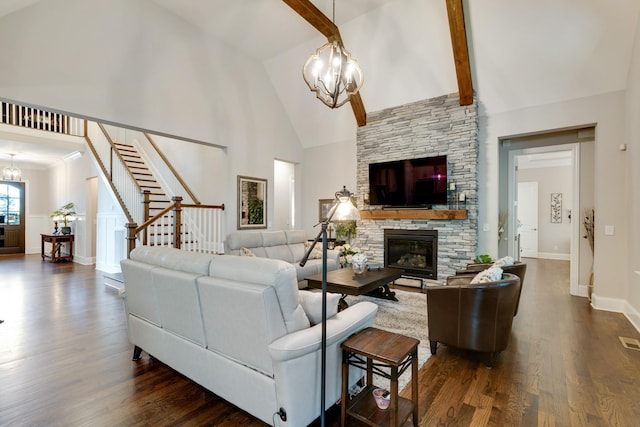 living room with dark wood-type flooring, a stone fireplace, an inviting chandelier, high vaulted ceiling, and beam ceiling