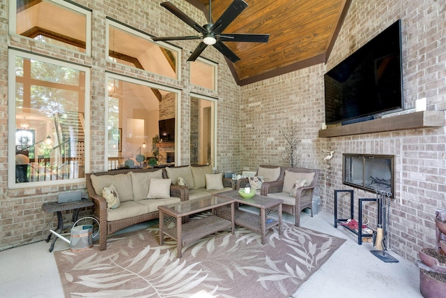 view of patio featuring ceiling fan and an outdoor living space with a fireplace