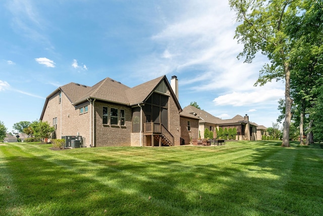 back of house with a lawn and central air condition unit