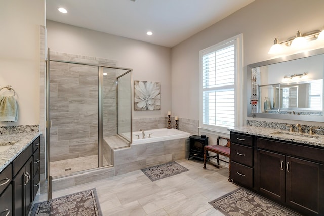 bathroom with separate shower and tub and vanity