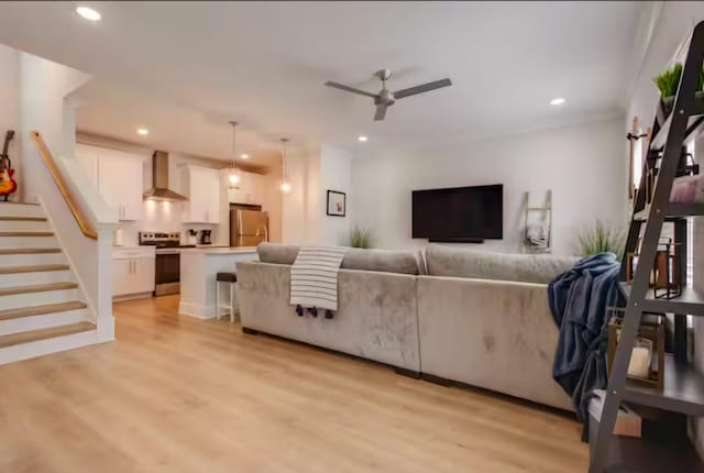 living room featuring ceiling fan and light wood-type flooring