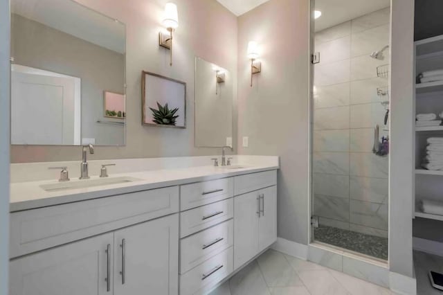 bathroom featuring walk in shower, vanity, and tile patterned flooring