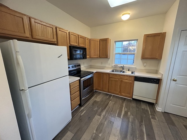 kitchen featuring dark hardwood / wood-style flooring, sink, and white appliances