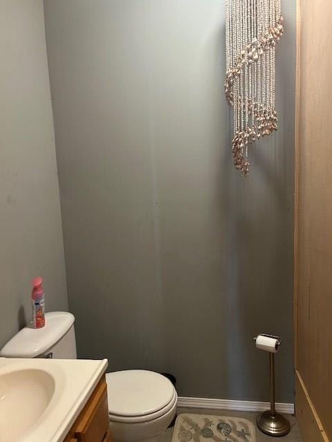 bathroom featuring toilet, tile patterned flooring, a chandelier, and vanity