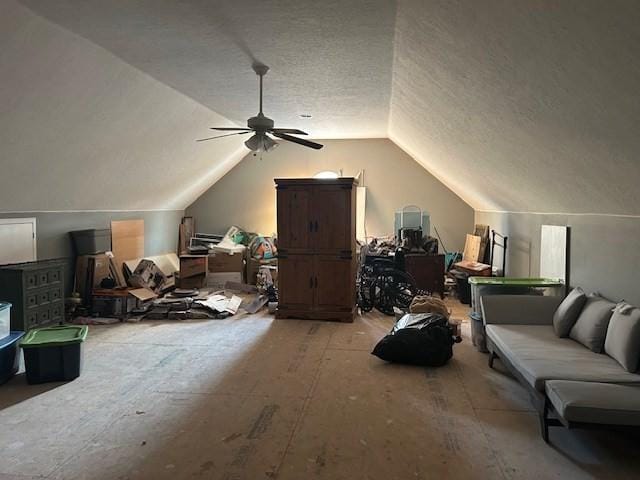 bonus room with ceiling fan, vaulted ceiling, and a textured ceiling