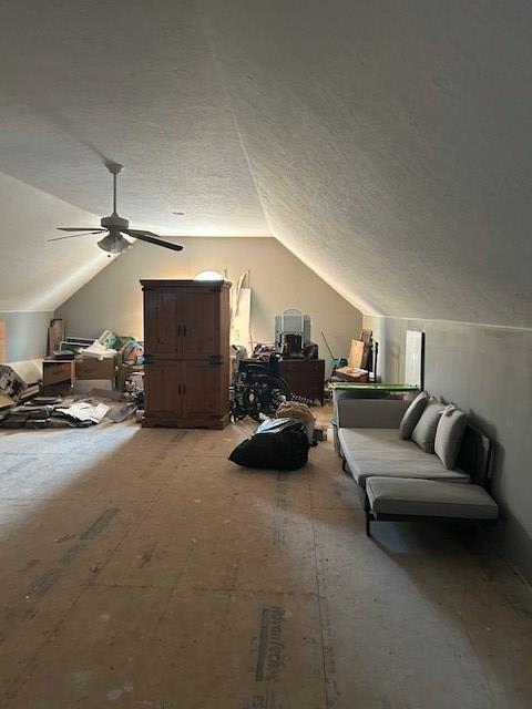 bonus room featuring a textured ceiling, ceiling fan, and lofted ceiling