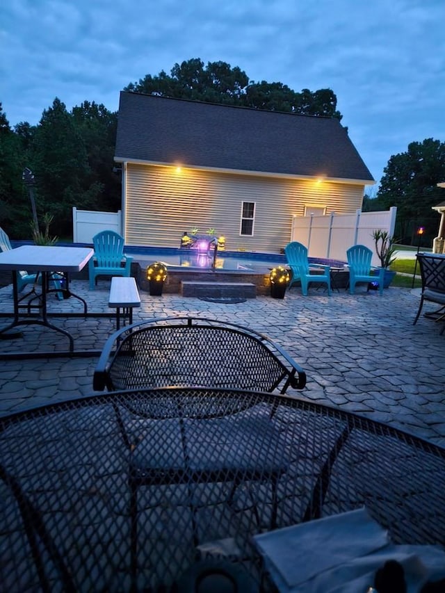 patio terrace at dusk with an outdoor fire pit