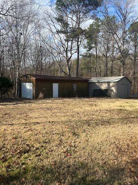 exterior space featuring a garage and a yard