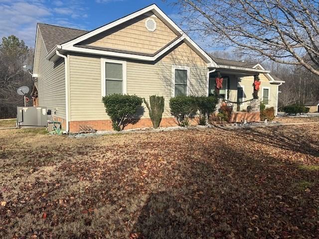 view of front of property with a porch and central AC