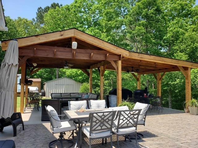 view of patio / terrace featuring ceiling fan, a storage shed, and an outdoor living space