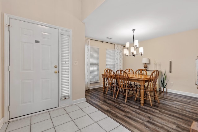 dining room with a chandelier and light wood-type flooring