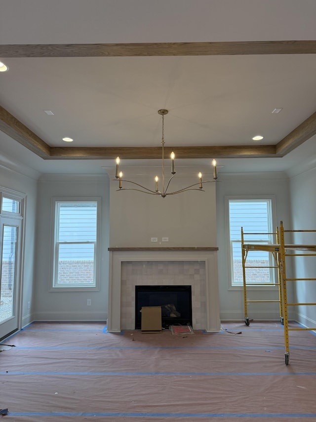 8013 Southvale Blvd, Franklin, TN 37064 - unfurnished living room featuring a raised ceiling, plenty of natural light, and a tile fireplace