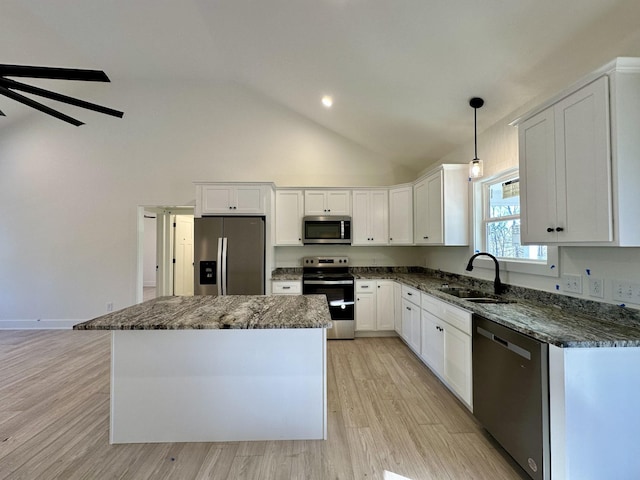 kitchen featuring a kitchen island, white cabinetry, stainless steel appliances, sink, and hanging light fixtures